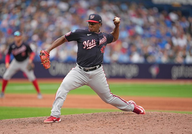 Aug 30, 2023; Toronto, Ontario, CAN; Washington Nationals relief pitcher Jose Ferrer (47) throws a pitch against the Toronto Blue Jays during the eighth inning at Rogers Centre. Mandatory Credit: Nick Turchiaro-USA TODAY Sports