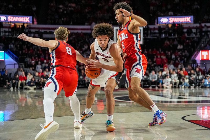 Jan 14, 2026; Athens, Georgia, USA; Georgia Bulldogs guard Jordan Ross (3) is defended by Mississippi Rebels guard Eduardo Klafke (8) and guard Ilias Kamardine (6) during the first half at Stegeman Coliseum. Mandatory Credit: Dale Zanine-Imagn Images
