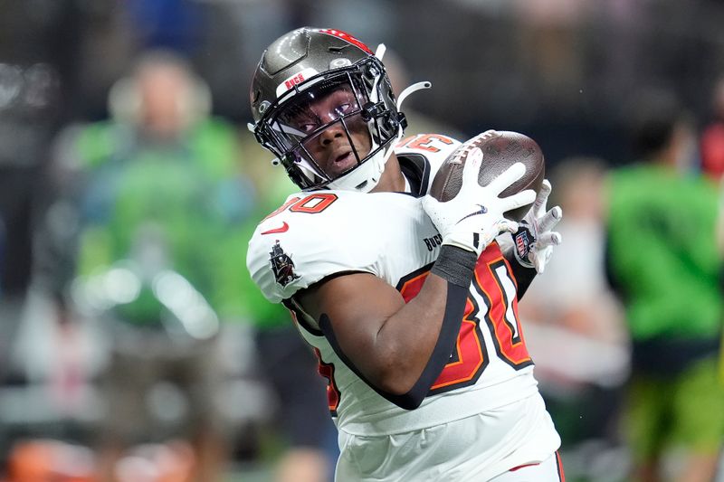 Tampa Bay Buccaneers running back DJ Williams warms up before an NFL football game against the New Orleans Saints in New Orleans, Sunday, Oct. 13, 2024. (AP Photo/Michael Conroy)