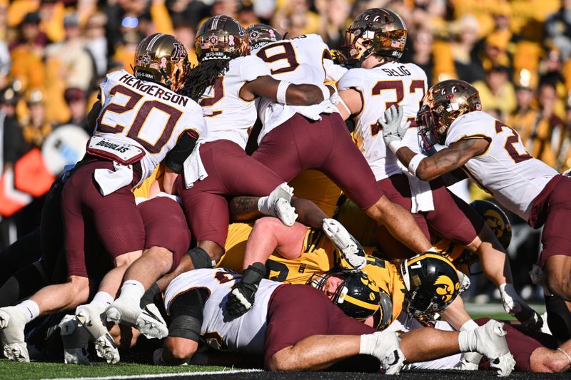 Oct 21, 2023; Iowa City, Iowa, USA; Minnesota Golden Gophers defensive back Jack Henderson (20) and linebacker Devon Williams (9) and linebacker Ryan Selig (33) and the Gophers defense stops the Iowa Hawkeyes offense at the goal line during the second quarter at Kinnick Stadium. Mandatory Credit: Jeffrey Becker-USA TODAY Sports