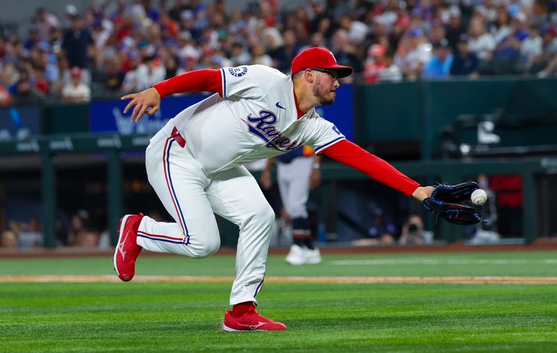 Aug 6, 2024; Arlington, Texas, USA; Texas Rangers starting pitcher Dane Dunning (33) makes a catch during the eighth inning against the Houston Astros at Globe Life Field. Mandatory Credit: Kevin Jairaj-USA TODAY Sports