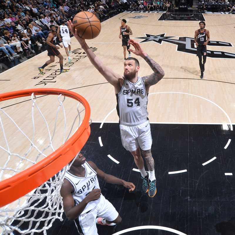 SAN ANTONIO, TX - APRIL 14: Sandro Mamukelashvili #54 of the San Antonio Spurs  grabs a rebound during the game against the Detroit Pistons on April 14, 2024 at the Frost Bank Center in San Antonio, Texas. NOTE TO USER: User expressly acknowledges and agrees that, by downloading and or using this photograph, user is consenting to the terms and conditions of the Getty Images License Agreement. Mandatory Copyright Notice: Copyright 2024 NBAE (Photos by Michael Gonzales/NBAE via Getty Images)