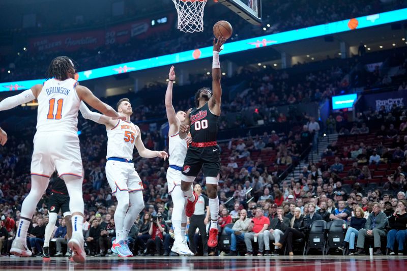 PORTLAND, OREGON - MARCH 14: Scoot Henderson #00 of the Portland Trail Blazers shoots the ball past Donte DiVincenzo #0 of the New York Knicks during the first half at Moda Center on March 14, 2024 in Portland, Oregon. NOTE TO USER: User expressly acknowledges and agrees that, by downloading and or using this photograph, User is consenting to the terms and conditions of the Getty Images License Agreement.  (Photo by Soobum Im/Getty Images)