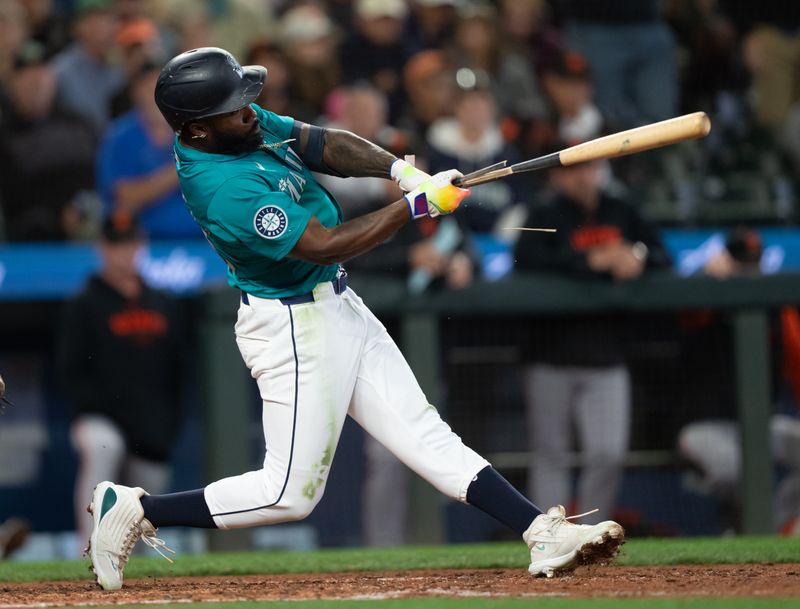 Aug 23, 2024; Seattle, Washington, USA; Seattle Mariners left fielder Randy Arozarena (56) hits into a fielder's choice that scored a run during the seventh inning during the seventh inning against the San Francisco Giants at T-Mobile Park. Mandatory Credit: Stephen Brashear-USA TODAY Sports