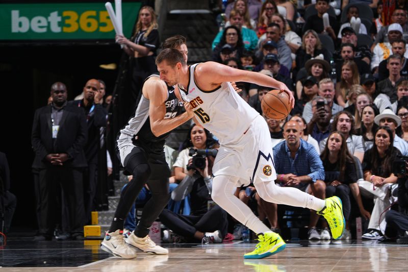 SAN ANTONIO, TX - APRIL 12: Nikola Jokic #15 of the Denver Nuggets dribbles the ball during the game against the San Antonio Spurs on April 12, 2024 at the Frost Bank Center in San Antonio, Texas. NOTE TO USER: User expressly acknowledges and agrees that, by downloading and or using this photograph, user is consenting to the terms and conditions of the Getty Images License Agreement. Mandatory Copyright Notice: Copyright 2024 NBAE (Photos by Garrett Ellwood/NBAE via Getty Images)