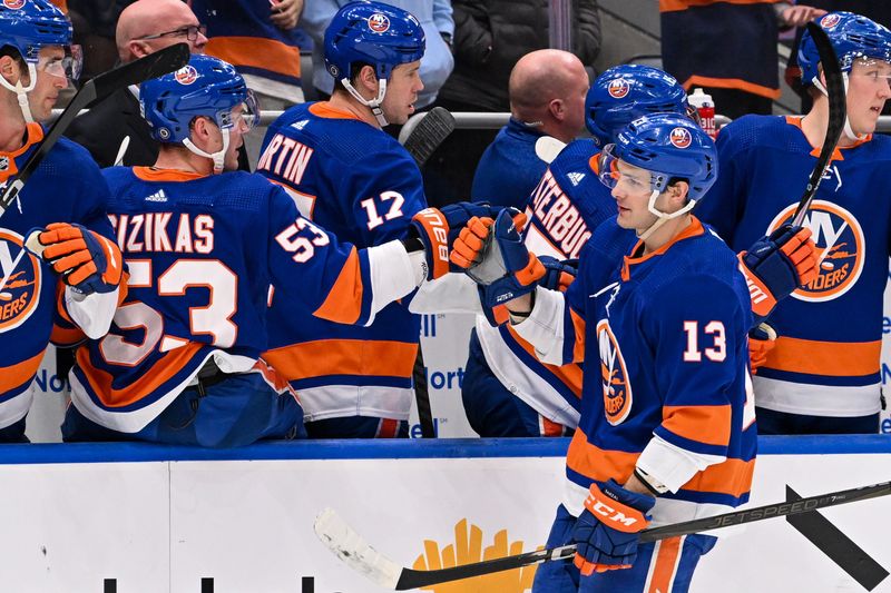 Feb 8, 2024; Elmont, New York, USA; New York Islanders center Mathew Barzal (13) celebrates his goal against the Tampa Bay Lightning with the New York Islanders bench during the first period at UBS Arena. Mandatory Credit: Dennis Schneidler-USA TODAY Sports