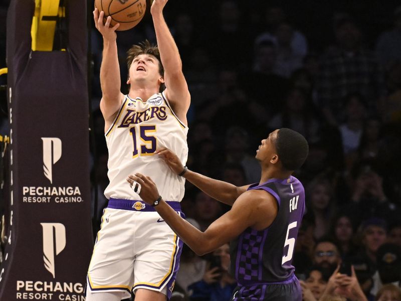 LOS ANGELES, CALIFORNIA - OCTOBER 26: Austin Reaves #15 of the Los Angeles Lakers shoots the ball while De'Aaron Fox #5 of the Sacramento Kings guards him in the first half at Crypto.com Arena on October 26, 2024 in Los Angeles, California. NOTE TO USER: User expressly acknowledges and agrees that, by downloading and or using this photograph, User is consenting to the terms and conditions of the Getty Images License Agreement. (Photo by John McCoy/Getty Images)