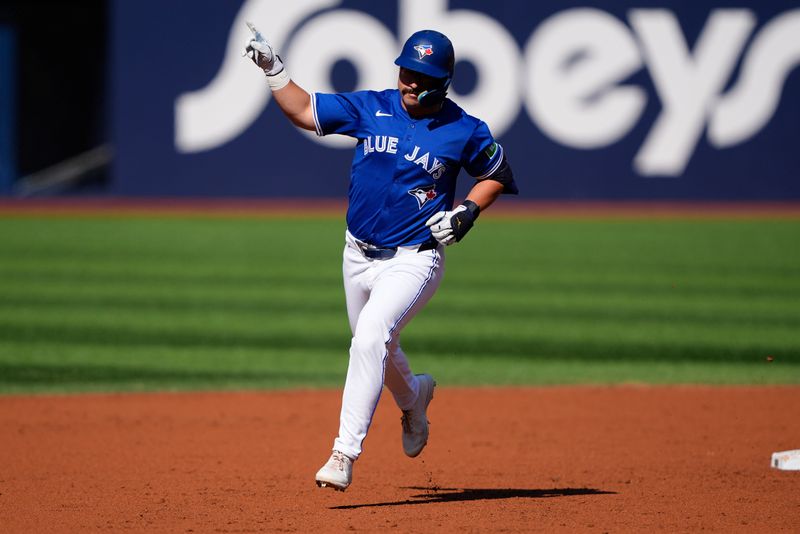 Sep 11, 2025; Toronto, Ontario, CAN; Toronto Blue Jays left fielder Davis Schneider (36) celebrates as he rounds the bases on a solo home run against the Houston Astros during the second inning at Rogers Centre. Mandatory Credit: John E. Sokolowski-Imagn Images