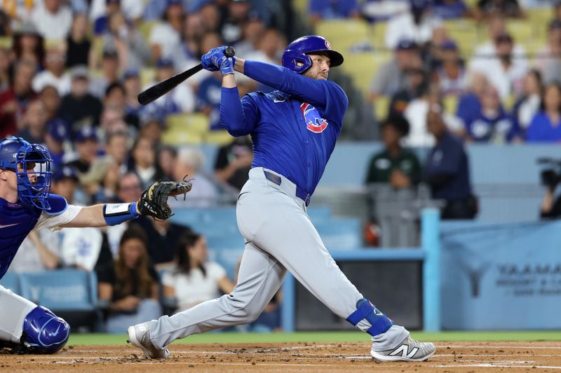 Sep 11, 2024; Los Angeles, California, USA;  Chicago Cubs first baseman Michael Busch (29) hits an RBI double during the first inning against the Los Angeles Dodgers at Dodger Stadium. Mandatory Credit: Kiyoshi Mio-Imagn Images