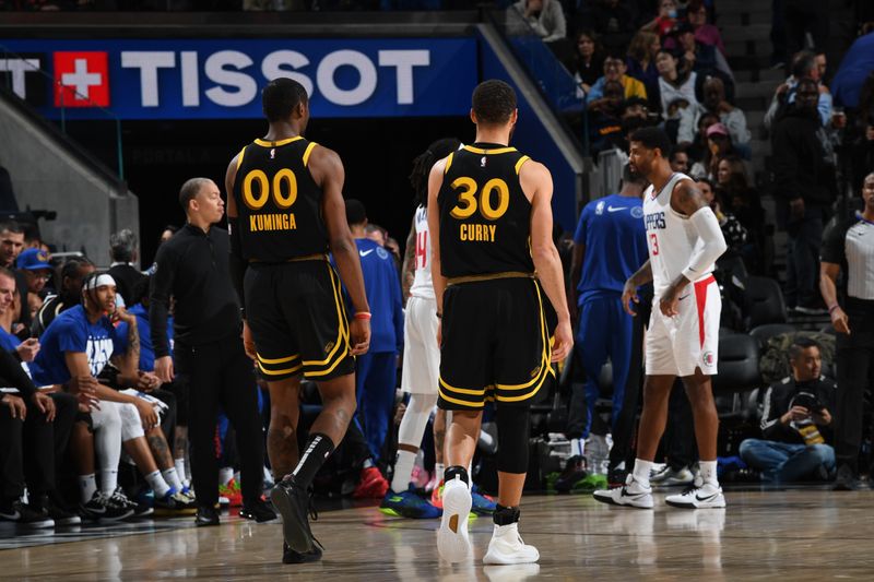 SAN FRANCISCO, CA - FEBRUARY 14: Jonathan Kuminga #00 and Stephen Curry #30 of the Golden State Warriors look on during the game against the LA Clippers on FEBRUARY 14, 2024 at Chase Center in San Francisco, California. NOTE TO USER: User expressly acknowledges and agrees that, by downloading and or using this photograph, user is consenting to the terms and conditions of Getty Images License Agreement. Mandatory Copyright Notice: Copyright 2024 NBAE (Photo by Noah Graham/NBAE via Getty Images)