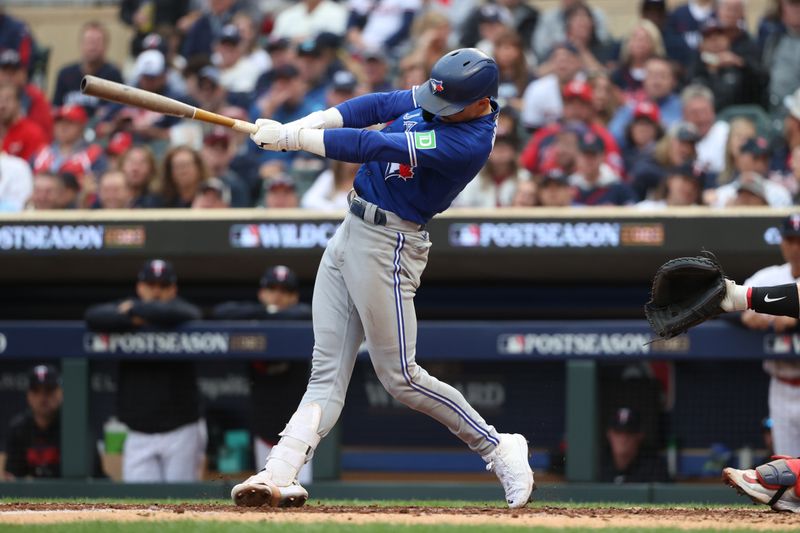 Oct 4, 2023; Minneapolis, Minnesota, USA; Toronto Blue Jays second baseman Cavan Biggio (8) hits a single in the sixth inning  during game two of the Wildcard series for the 2023 MLB playoffs at Target Field. Mandatory Credit: Jesse Johnson-USA TODAY Sports