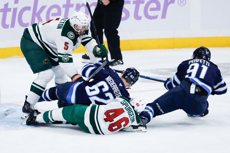 Nov 23, 2025; Winnipeg, Manitoba, CAN;  Minnesota Wild defenseman Jake Middleton (5), Minnesota Wild defenseman Jared Spurgeon (46), Winnipeg Jets forward Nino Niederreiter (62) and Winnipeg Jets forward Cole Perfetti (91) battle for the puck during the third period at Canada Life Centre. Mandatory Credit: Terrence Lee-Imagn Images