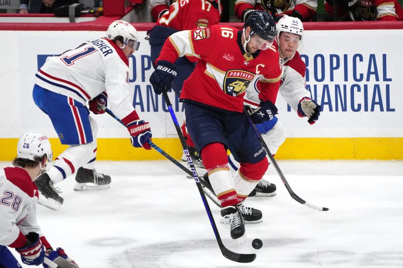 Dec 30, 2023; Sunrise, Florida, USA;  Florida Panthers center Aleksander Barkov (16) battles for the puck with Montreal Canadiens defenseman Jordan Harris (54) and right wing Brendan Gallagher (11) during the second period at Amerant Bank Arena. Mandatory Credit: Jim Rassol-USA TODAY Sports