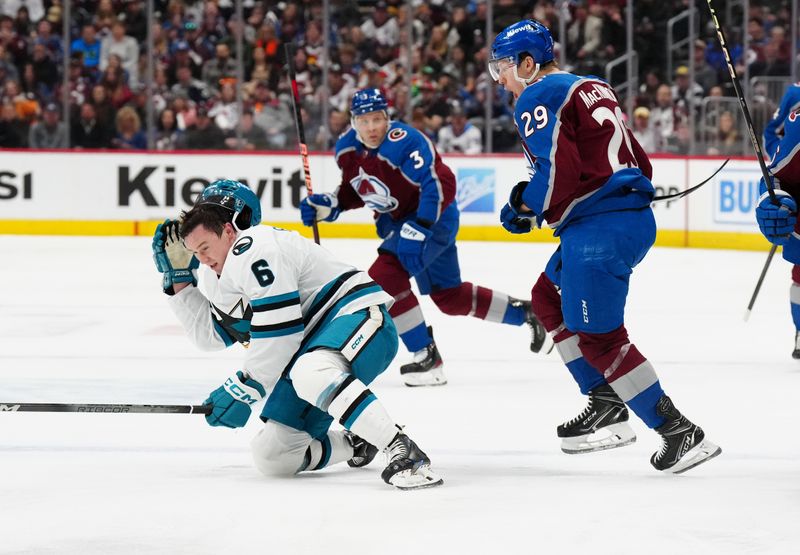 Dec 31, 2023; Denver, Colorado, USA; Colorado Avalanche center Nathan MacKinnon (29) reacts after his hit on San Jose Sharks defenseman Ty Emberson (6) in the second period at Ball Arena. Mandatory Credit: Ron Chenoy-USA TODAY Sports