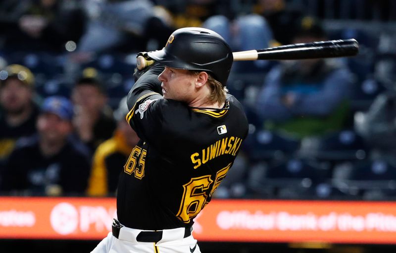 Apr 22, 2024; Pittsburgh, Pennsylvania, USA;  Pittsburgh Pirates left fielder outfielder Jack Suwinski (65) drives in a run against the Milwaukee Brewers during the sixth inning at PNC Park. Mandatory Credit: Charles LeClaire-USA TODAY Sports