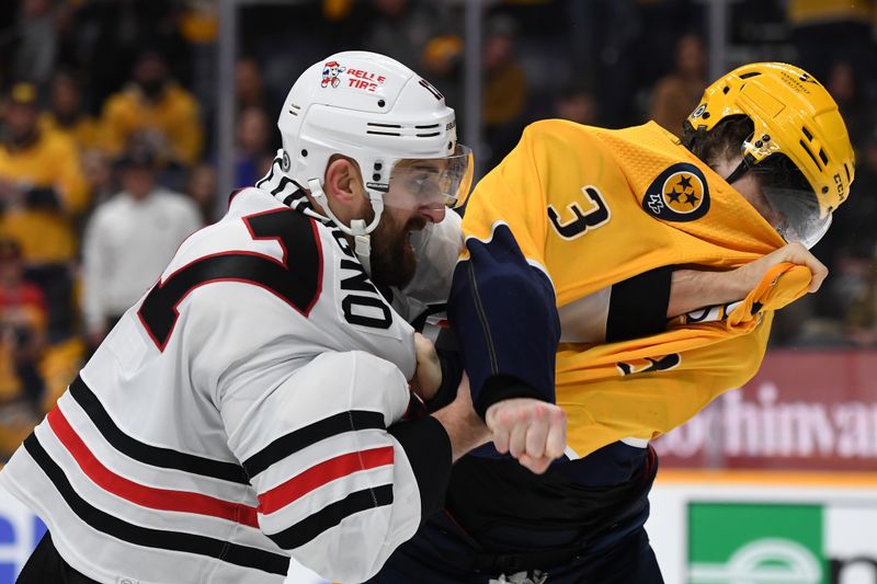 Jan 2, 2024; Nashville, Tennessee, USA; Chicago Blackhawks left wing Nick Foligno (17) and Nashville Predators defenseman Jeremy Lauzon (3) exchange punches during a fight in the second period at Bridgestone Arena. Mandatory Credit: Christopher Hanewinckel-USA TODAY Sports