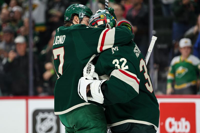 Oct 10, 2024; Saint Paul, Minnesota, USA; Minnesota Wild goaltender Filip Gustavsson (32) and left wing Marcus Foligno (17) celebrate their teams win against the Columbus Blue Jackets after the game at Xcel Energy Center. Mandatory Credit: Matt Krohn-Imagn Images