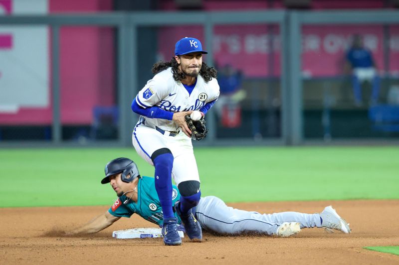 Sep 16, 2025; Kansas City, Missouri, USA; Seattle Mariners pinch runner Leo Rivas (76) slides into second base as Kansas City Royals second baseman Jonathan India (6) stops the ball during the top of the eighth inning at Kauffman Stadium. Mandatory Credit: Scott Sewell-Imagn Images