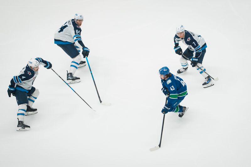 Nov 11, 2025; Vancouver, British Columbia, CAN; Winnipeg Jets defenseman Neal Pionk (4) and defenseman Logan Stanley (64) and forward Vladislav Namestnikov (7) defend against Vancouver Canucks defenseman Quinn Hughes (43) in the third period at Rogers Arena. Mandatory Credit: Bob Frid-Imagn Images