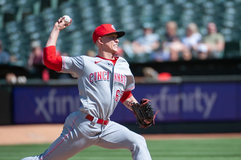 Apr 29, 2023; Oakland, California, USA; Cincinnati Reds relief pitcher Casey Legumina (65) throws a pitch during the eighth inning against the Oakland Athletics at RingCentral Coliseum. Mandatory Credit: Ed Szczepanski-USA TODAY Sports