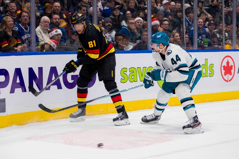 Dec 23, 2023; Vancouver, British Columbia, CAN; San Jose Sharks defenseman Marc-Edouard Vlasic (44) stick checks Vancouver Canucks forward Dakota Joshua (81) in the first period at Rogers Arena. Mandatory Credit: Bob Frid-USA TODAY Sports