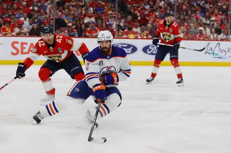 Jun 18, 2024; Sunrise, Florida, USA; Edmonton Oilers defenseman Evan Bouchard (2) controls the puck during the third period against the Florida Panthers in game five of the 2024 Stanley Cup Final at Amerant Bank Arena. Mandatory Credit: Sam Navarro-USA TODAY Sports