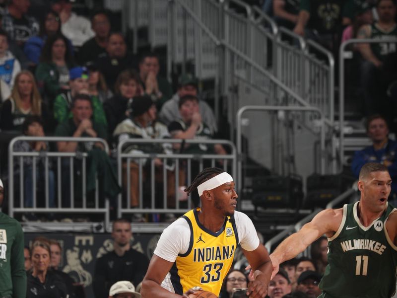 MILWAUKEE, WI - APRIL 21: Myles Turner #33 of the Indiana Pacers dribbles the ball during the game against the Milwaukee Bucks during Round 1 Game 1 of the 2024 NBA Playoffs on April 21, 2024 at the Fiserv Forum Center in Milwaukee, Wisconsin. NOTE TO USER: User expressly acknowledges and agrees that, by downloading and or using this Photograph, user is consenting to the terms and conditions of the Getty Images License Agreement. Mandatory Copyright Notice: Copyright 2024 NBAE (Photo by Gary Dineen/NBAE via Getty Images).