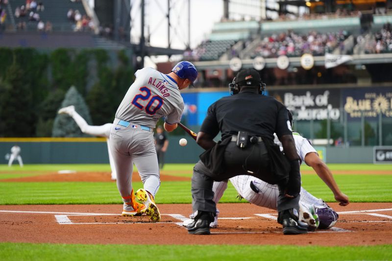 Aug 7, 2024; Denver, Colorado, USA; New York Mets first base Pete Alonso (20) RBI singles in the first inning against the Colorado Rockies at Coors Field. Mandatory Credit: Ron Chenoy-USA TODAY Sports