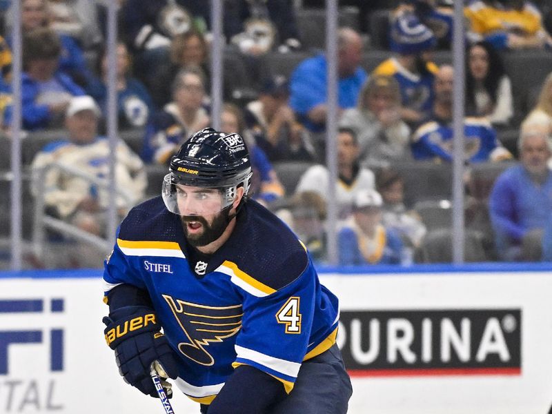 Nov 7, 2023; St. Louis, Missouri, USA;  St. Louis Blues defenseman Nick Leddy (4) controls the puck against the Winnipeg Jets during the second period at Enterprise Center. Mandatory Credit: Jeff Curry-USA TODAY Sports