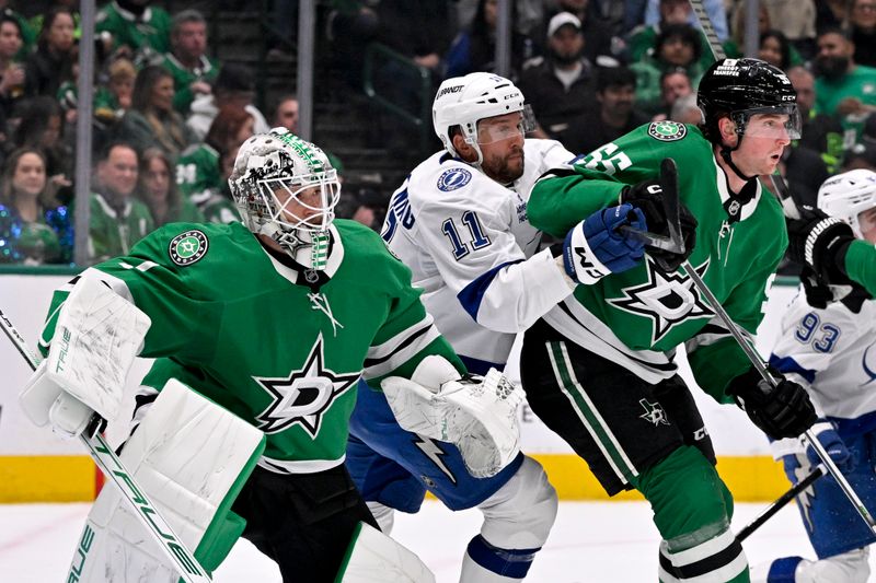 Mar 20, 2025; Dallas, Texas, USA; Tampa Bay Lightning center Luke Glendening (11) battle for position between Dallas Stars goaltender Casey DeSmith (1) and defenseman Thomas Harley (55) during the first period at the American Airlines Center. Mandatory Credit: Jerome Miron-Imagn Images