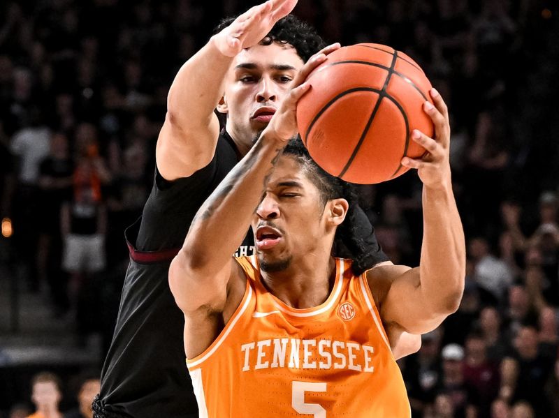 Feb 21, 2023; College Station, Texas, USA;  Tennessee Volunteers guard Zakai Zeigler (5) drives to the basket as Texas A&M Aggies guard Andre Gordon (20) defends during the first half at Reed Arena. Mandatory Credit: Maria Lysaker-USA TODAY Sports