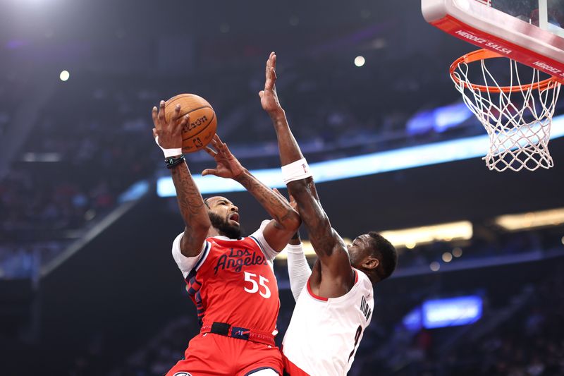 INGLEWOOD, CALIFORNIA - DECEMBER 03: Derrick Jones Jr. #55 of the LA Clippers dunks over Deandre Ayton #2 of the Portland Trail Blazers in the first quarter of an Emirates NBA Cup game at Intuit Dome on December 03, 2024 in Inglewood, California. NOTE TO USER: User expressly acknowledges and agrees that, by downloading and or using this photograph, User is consenting to the terms and conditions of the Getty Images License Agreement. (Photo by Katelyn Mulcahy/Getty Images)