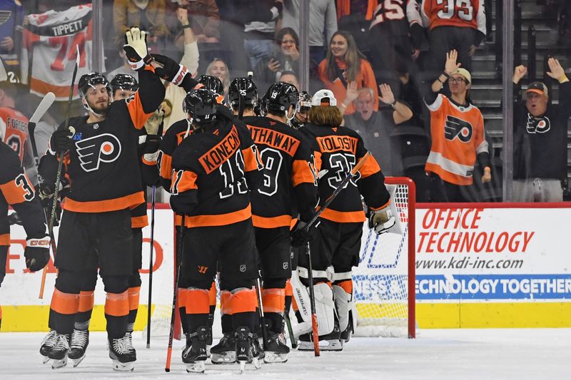 Oct 31, 2024; Philadelphia, Pennsylvania, USA; Philadelphia Flyers center Sean Couturier (14) and right wing Travis Konecny (11) celebrate win against the St. Louis Blues at Wells Fargo Center. Mandatory Credit: Eric Hartline-Imagn Images