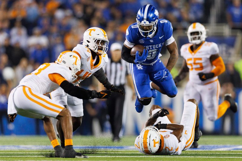 Oct 28, 2023; Lexington, Kentucky, USA; Kentucky Wildcats running back Demie Sumo-Karngbaye (0) evades Tennessee Volunteers defenders during the fourth quarter at Kroger Field. Mandatory Credit: Jordan Prather-USA TODAY Sports