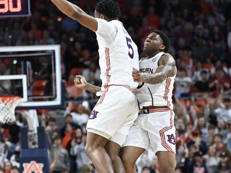 Feb 14, 2023; Auburn, Alabama, USA;  Auburn Tigers forward Chris Moore (5) and Auburn Tigers guard K.D. Johnson (0) celebrate a score over the Missouri Tigers during the first half at Neville Arena. Mandatory Credit: Julie Bennett-USA TODAY Sports