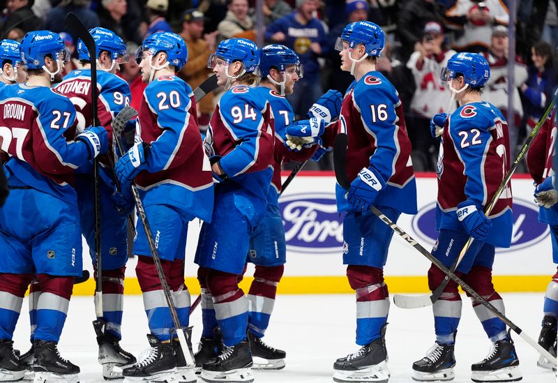 Jan 14, 2025; Denver, Colorado, USA; Colorado Avalanche defenseman Devon Toews (7) (center) celebrates his overtime goal against the New York Rangers at Ball Arena. Mandatory Credit: Ron Chenoy-Imagn Images