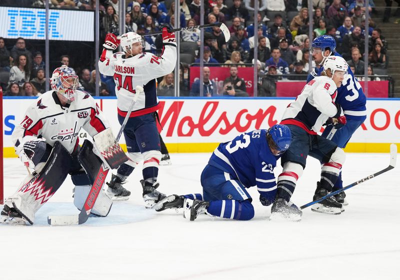 Dec 6, 2024; Toronto, Ontario, CAN; Toronto Maple Leafs center Auston Matthews (34) battles with Washington Capitals defenseman Jakob Chychrun (6) during the third period at Scotiabank Arena. Mandatory Credit: Nick Turchiaro-Imagn Images