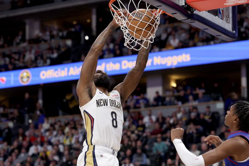 DENVER, COLORADO - JANUARY 12: Naji Marshall #8 of the New Orleans Pelicans dunks against Peyton Watson #8 of the Denver Nuggets in the third quarter at Ball Arena on January 12, 2024 in Denver, Colorado. NOTE TO USER: User expressly acknowledges and agrees that, by downloading and or using this photograph, User is consenting to the terms and conditions of the Getty Images License Agreement.  (Photo by Matthew Stockman/Getty Images)