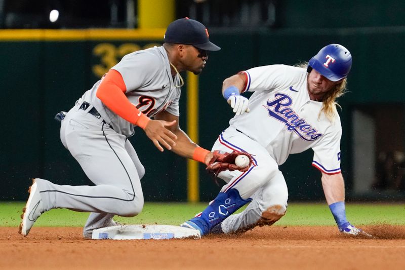 Jun 29, 2023; Arlington, Texas, USA; Texas Rangers left fielder Travis Jankowski (16) slides into second base with a double as Detroit Tigers third baseman Andy Ibanez (77) apples the tag late during the fifth inning at Globe Life Field. Mandatory Credit: Raymond Carlin III-USA TODAY Sports