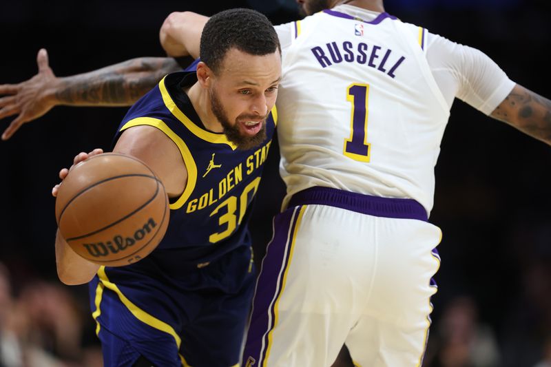 LOS ANGELES, CALIFORNIA - MARCH 16: Stephen Curry #30 of the Golden State Warriors dribbles around the defense of D'Angelo Russell #1 of the Los Angeles Lakers during the second half of a game against the Golden State Warriors at Crypto.com Arena on March 16, 2024 in Los Angeles, California. NOTE TO USER: User expressly acknowledges and agrees that, by downloading and or using this photograph, User is consenting to the terms and conditions of the Getty Images License Agreement. (Photo by Sean M. Haffey/Getty Images)