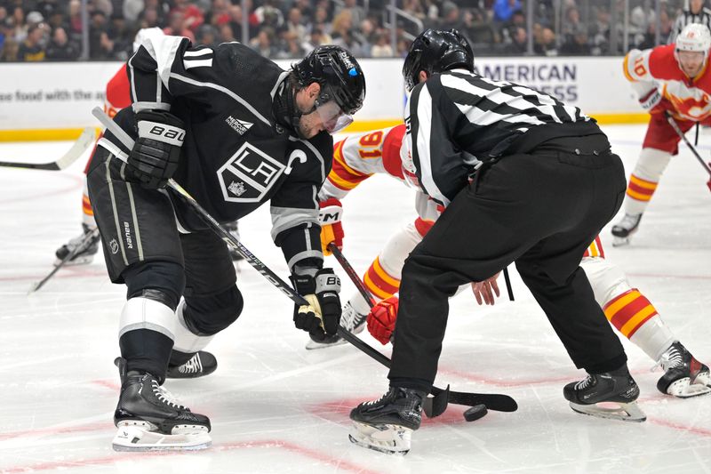 Apr 11, 2024; Los Angeles, California, USA;  Los Angeles Kings center Anze Kopitar (11) wins a face off against Calgary Flames center Nazem Kadri (91) in the first period at Crypto.com Arena. Mandatory Credit: Jayne Kamin-Oncea-USA TODAY Sports