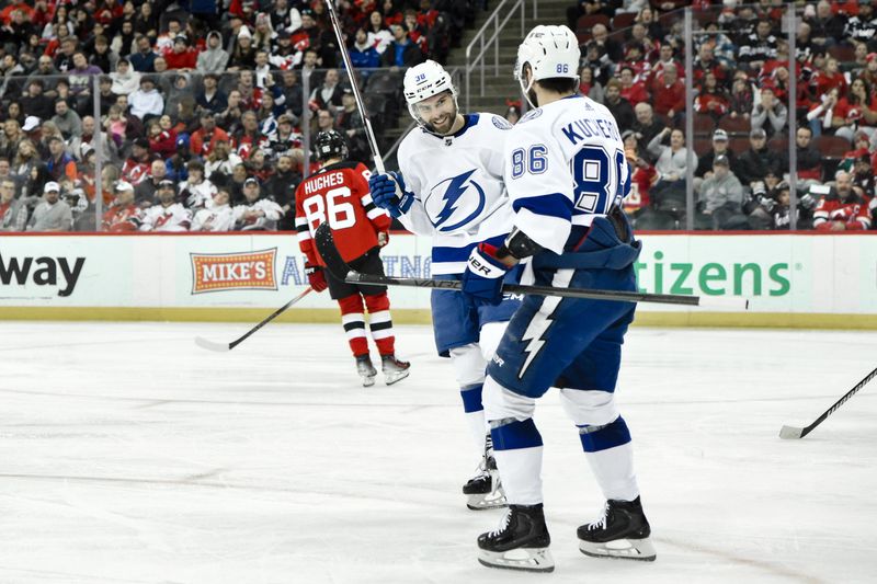 Feb 25, 2024; Newark, New Jersey, USA; Tampa Bay Lightning left wing Brandon Hagel (38) celebrates with Tampa Bay Lightning right wing Nikita Kucherov (86) after scoring a goal against the New Jersey Devils during the third period at Prudential Center. Mandatory Credit: John Jones-USA TODAY Sports