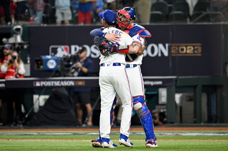 Oct 10, 2023; Arlington, Texas, USA; Texas Rangers relief pitcher Jose Leclerc (25) and catcher Jonah Heim (28) celebrate after defeating the Baltimore Orioles in game three of the ALDS for the 2023 MLB playoffs at Globe Life Field. Mandatory Credit: Jerome Miron-USA TODAY Sports