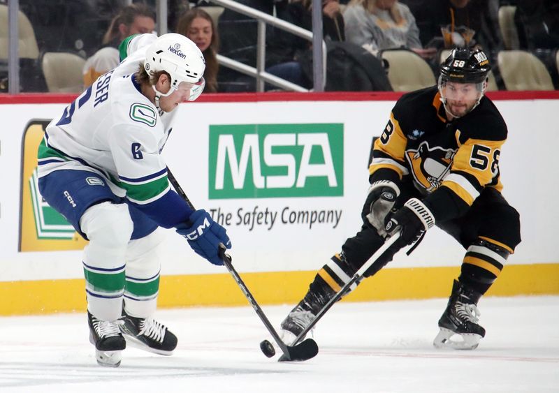 Nov 27, 2024; Pittsburgh, Pennsylvania, USA;  Vancouver Canucks right wing Brock Boeser (6) and Pittsburgh Penguins defenseman Kris Letang (58) battle for the puck during the first period at PPG Paints Arena. Mandatory Credit: Charles LeClaire-Imagn Images