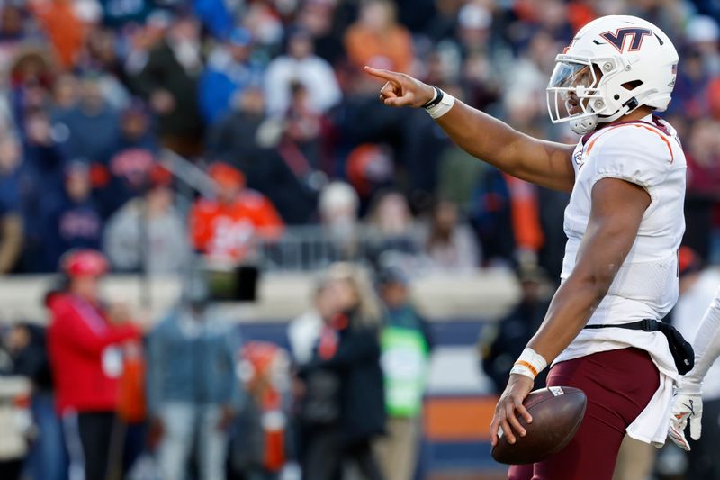 Nov 25, 2023; Charlottesville, Virginia, USA; Virginia Tech Hokies quarterback Kyron Drones (1) celebrates after running for a first down against the Virginia Cavaliers during the first quarter at Scott Stadium. Mandatory Credit: Geoff Burke-USA TODAY Sports