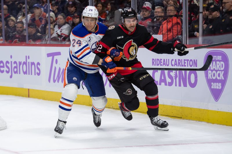 Nov 19, 2024; Ottawa, Ontario, CAN; Edmonton Oilers defenseman Travis Dermott (24) battles with Ottawa Senators right wing Michael Amadio (22) in the first period at the Canadian Tire Centre. Mandatory Credit: Marc DesRosiers-Imagn Images