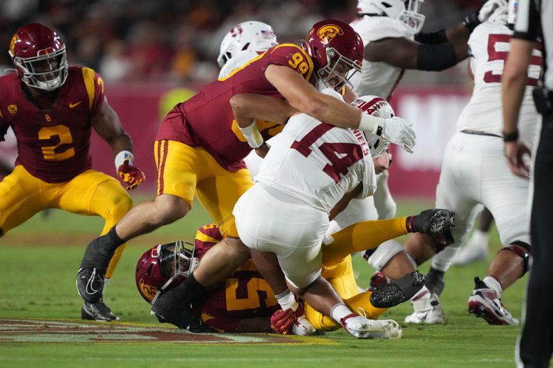 Sep 9, 2023; Los Angeles, California, USA; Southern California Trojans defensive lineman Jack Sullivan (99) hits Stanford Cardinal quarterback Ashton Daniels (14) in the first half at United Airlines Field at Los Angeles Memorial Coliseum. Mandatory Credit: Kirby Lee-USA TODAY Sports