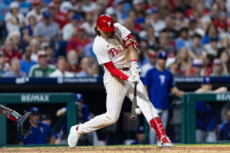 May 21, 2024; Philadelphia, Pennsylvania, USA; Philadelphia Phillies third base Alec Bohm (28) hits an RBI double during the eighth inning against the Texas Rangers at Citizens Bank Park. Mandatory Credit: Bill Streicher-USA TODAY Sports