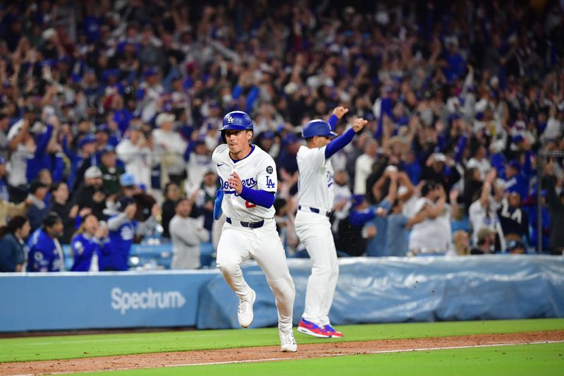 June 3, 2025; Los Angeles, California, USA; Los Angeles Dodgers second base Tommy Edman (25) runs home to score after first baseman Freddie Freeman (5) hits a walk off RBI double against the New York Mets during the tenth inning at Dodger Stadium. Mandatory Credit: Gary A. Vasquez-Imagn Images