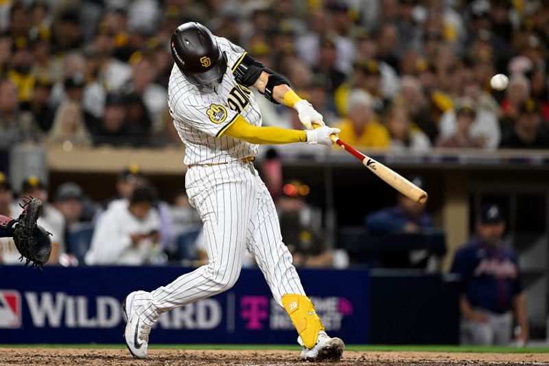 Oct 1, 2024; San Diego, California, USA; San Diego Padres catcher Kyle Higashioka (20) hits a solo home run against the Atlanta Braves during the eighth inning in game one of the Wildcard round for the 2024 MLB Playoffs at Petco Park. Mandatory Credit: Denis Poroy-Imagn Images